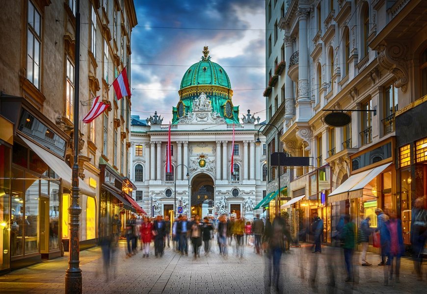 The pedestrian zone Herrengasse with a view towards imperial Hofburg palace in Vienna, Austria.