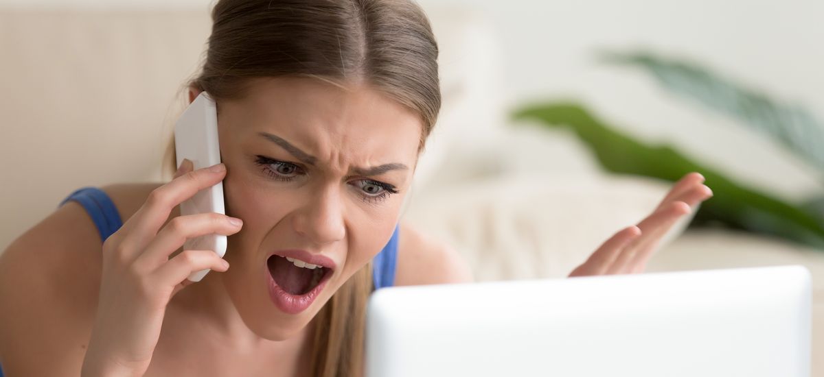 Angry dissatisfied young woman calling customer support or mobile banking, displeased client complaining about bad service, arguing on phone, having conflict during telephone conversation at home