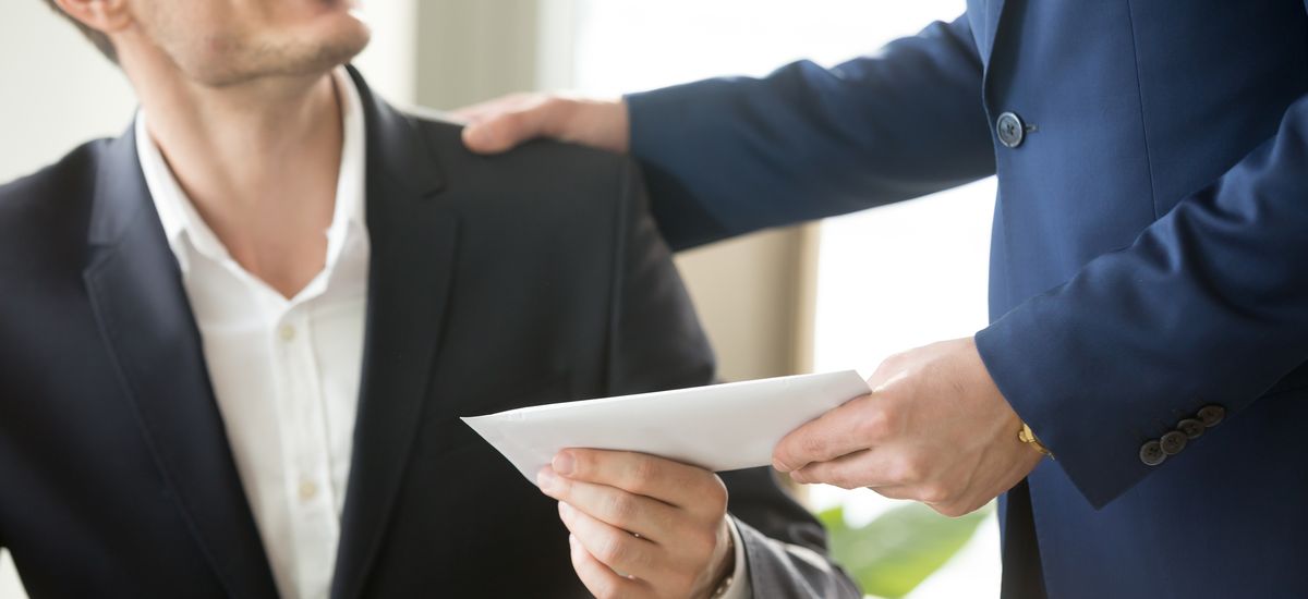 Company leader giving money bonus in paper envelope to happy smiling office worker, congratulating employee with increasing of salary or promotion, thanking for successes in work. Close up concept