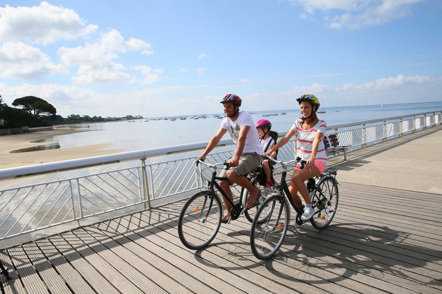 Family on a biking journey by the sea