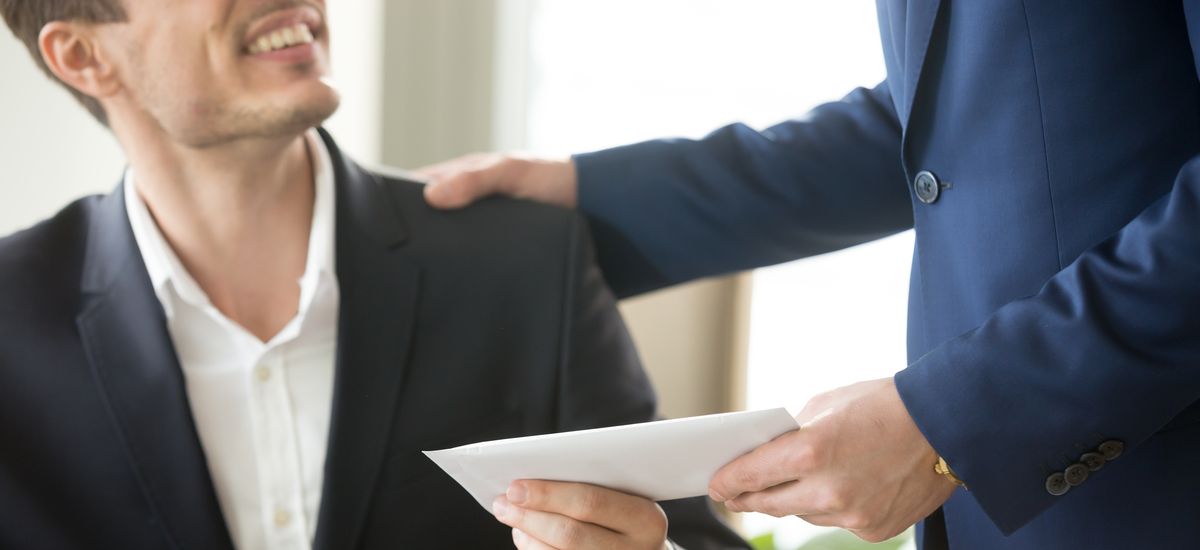 Company leader giving money bonus in paper envelope to happy smiling office worker, congratulating employee with increasing of salary or promotion, thanking for successes in work. Close up concept