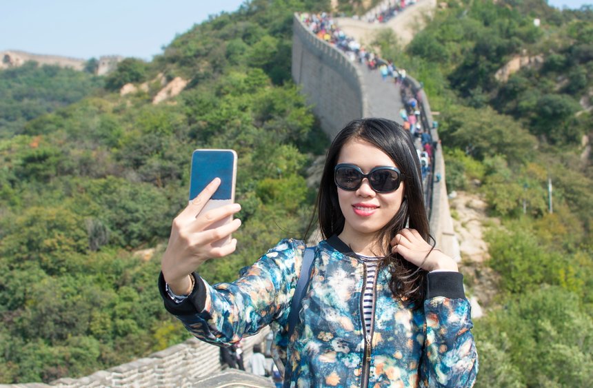 Girl making selfie at the Great wall of China