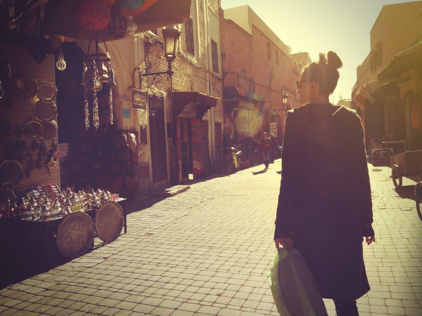 Young woman shopping in the Marrakech Medina at sunset