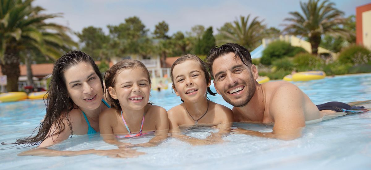 Cheerful family in hotel swimming-pool