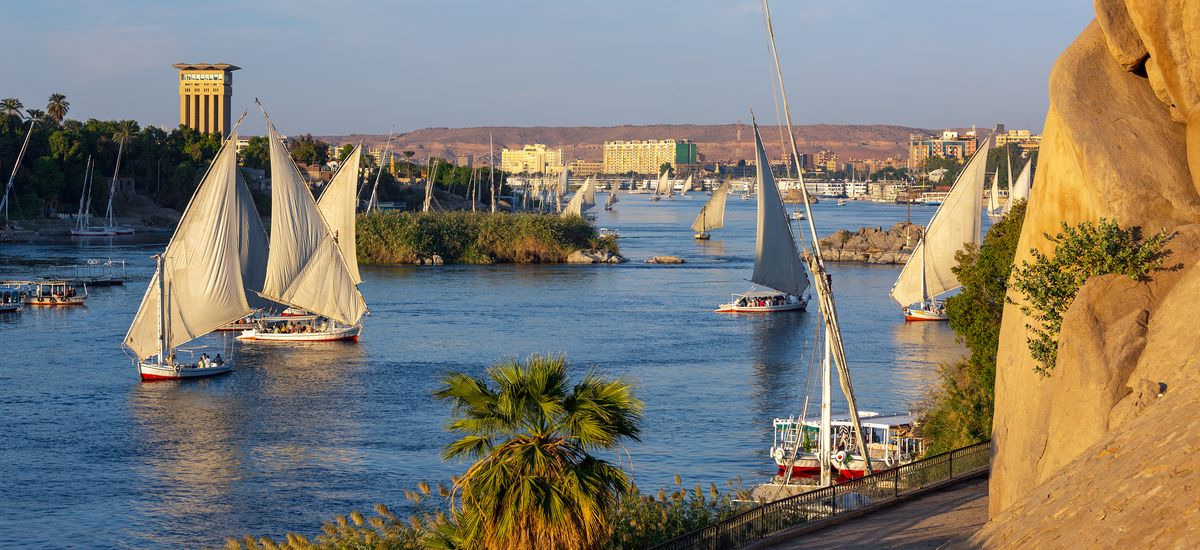 Beautiful landscape with felucca boats on Nile river in Aswan at sunset, Egypt