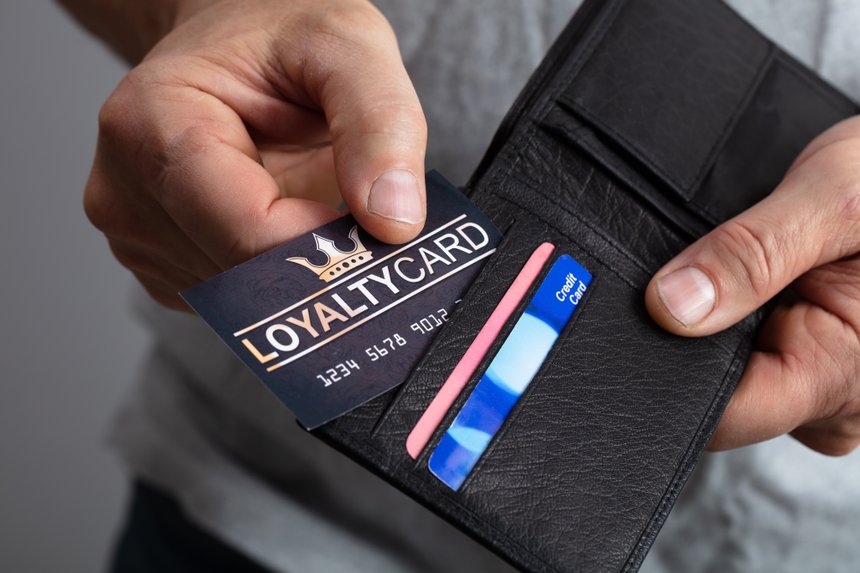 Person Removing Loyalty Card From Wallet