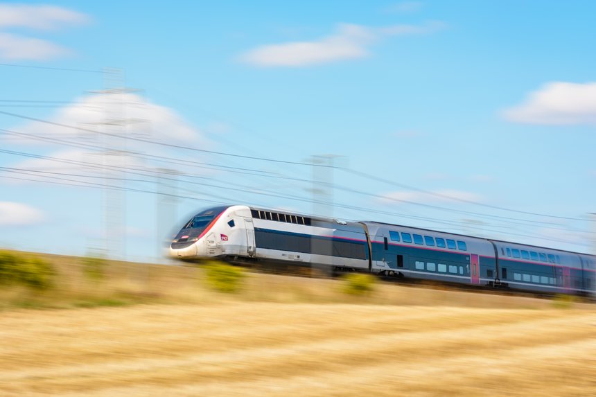 Varreddes, France - August 18, 2018: A TGV Duplex high-speed train in Carmillon livery from french company SNCF driving at full speed on the East European high-speed line (artist's impression).