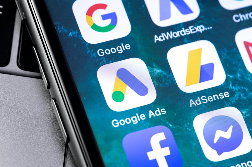 closeup keyboard laptop and Google Ads AdWords app icon on smartphone screen. Google is the biggest Internet search engine in the world. Moscow, Russia - April 27, 2019