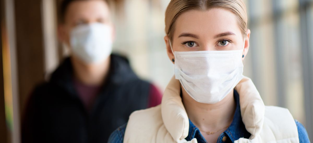 Man and woman wearing protective mask against transmissible infectious diseases and as protection against the flu. New coronavirus 2019-nCoV from China