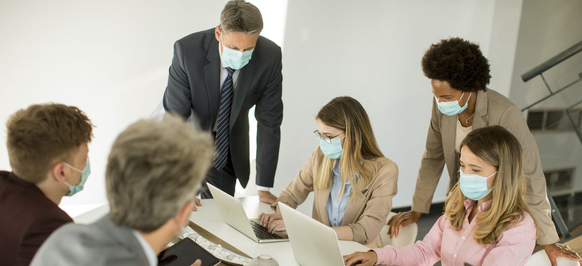 Group business people have a meeting and working in office and wear masks as protection from corona virus