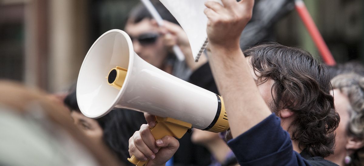 demostrator with megaphone and notebook protesting