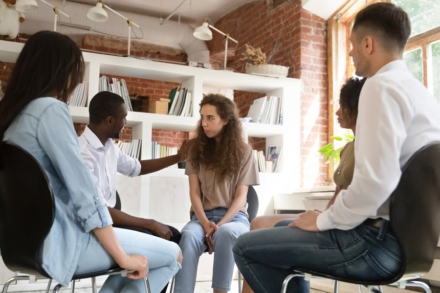 Diverse people gather together at group therapy discuss personal problems