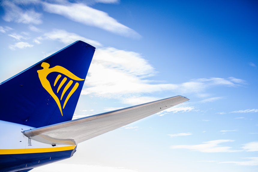 Valencia, Spain - March 8, 2019: Tail of a plane of the Ryanair travel company, isolated with blue cloud background.