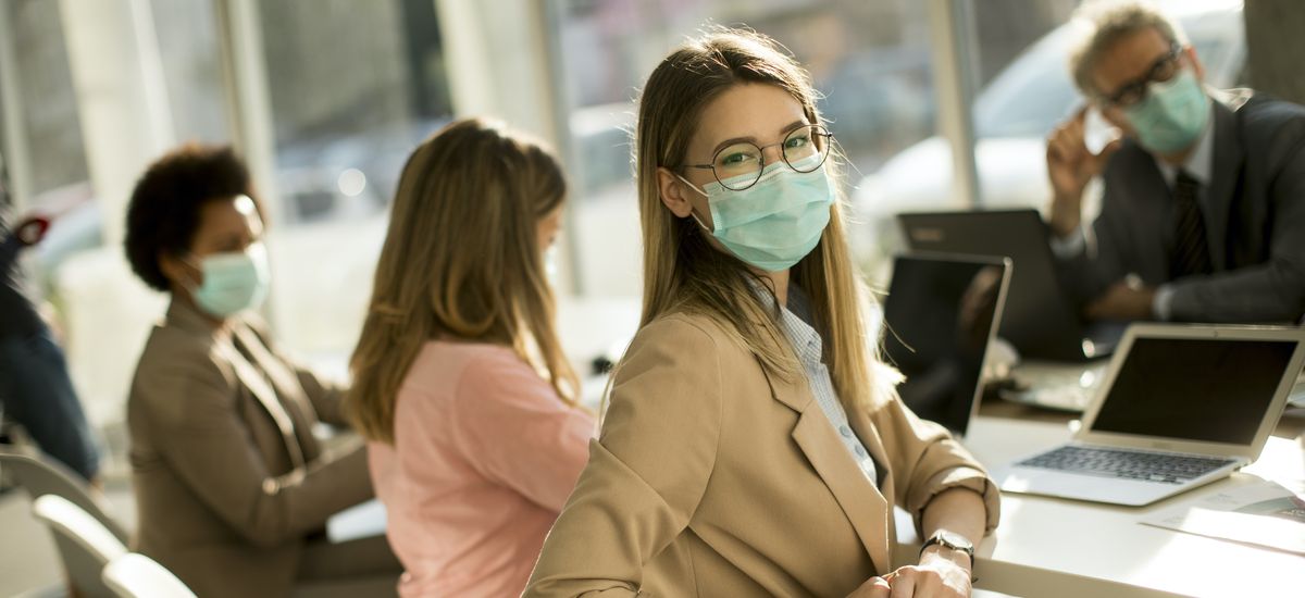 Young woman with group of business people have a meeting and working in office and wear mask as protection from corona virus