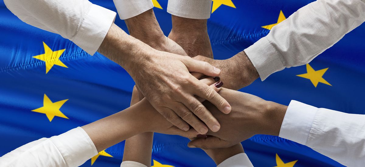 Multicultural hands union concept over european flag