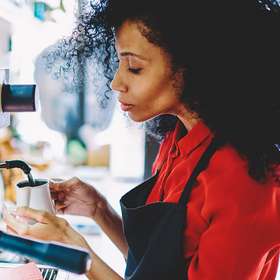 Side view of pensive african american female waitress in black a