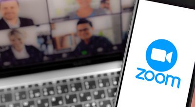 Zoom logo on the screen smartphone and notebook background closeup. Zoom Video Communications is a company that provides remote conferencing services. Moscow, Russia - April 1, 2020