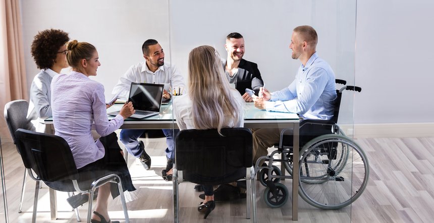 Disabled Manager Sitting With His Colleagues