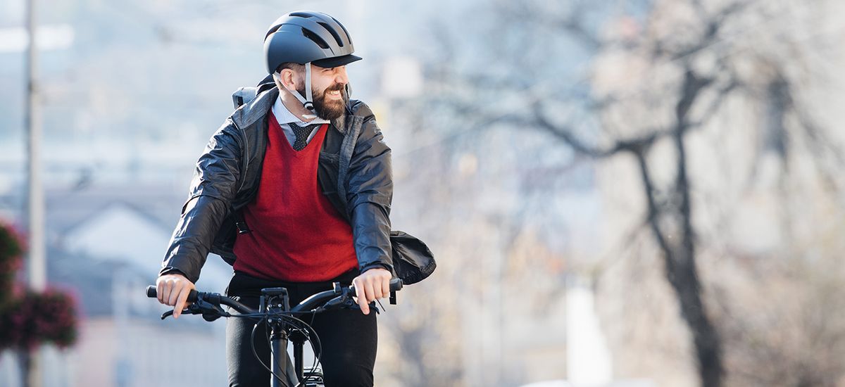 Hipster businessman commuter with bicycle traveling to work in c