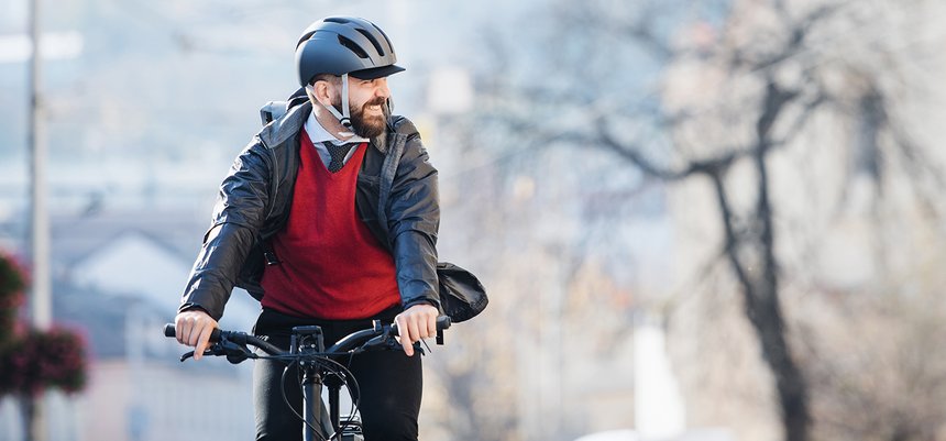 Hipster businessman commuter with bicycle traveling to work in c