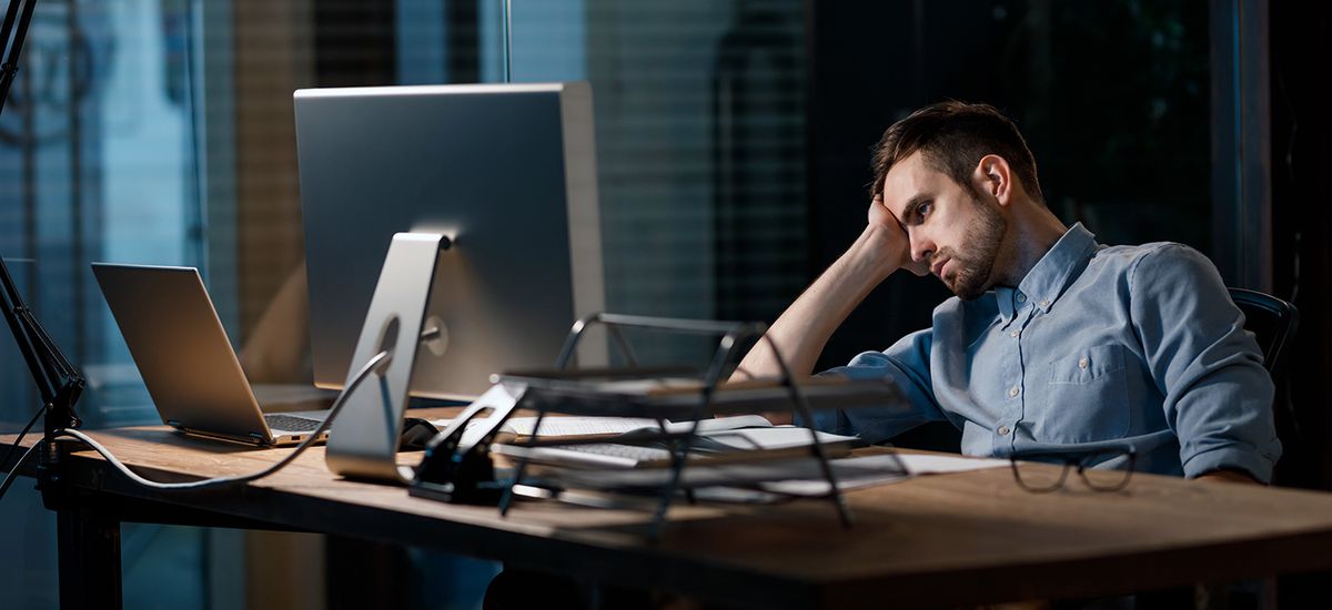 Exhausted worker watching computer