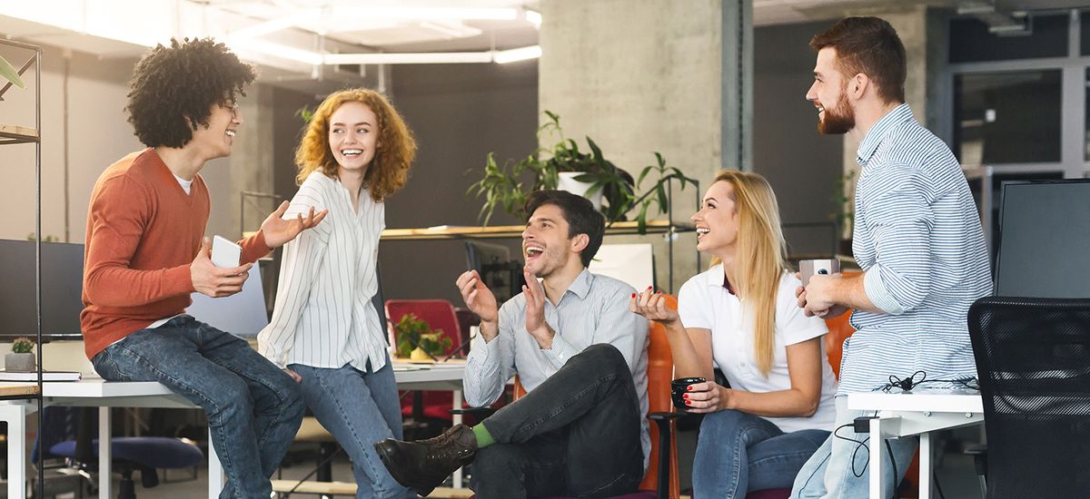 Diverse millennial people having good talk at coworking space