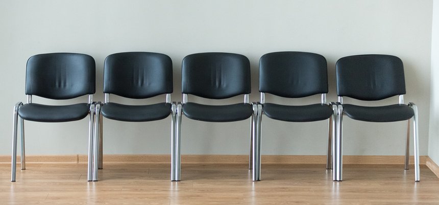 Row of black office chairs in conference room