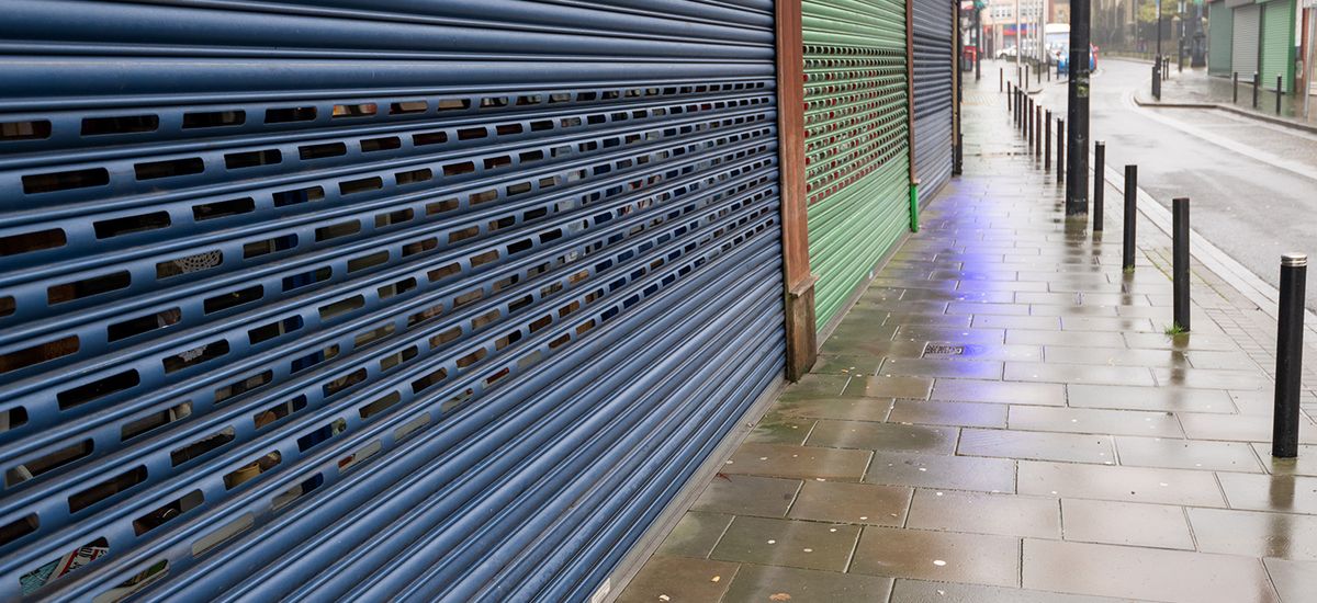 High Street Shops closing down with shutters closed, decline in 