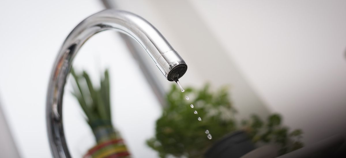 Kitchen tap isolated on bright background. Water saving solution