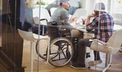 Full length of handicap businessman discussing with colleague