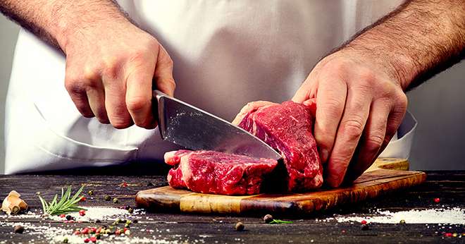 Man cutting beef meat