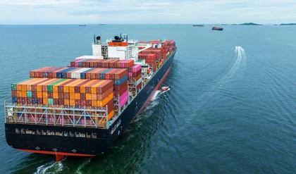 Aerial Stern view of cargo container ship carrying container from custom container depot go to ocean concept freight shipping by ship service on blue sky .Freight Forwarding Service