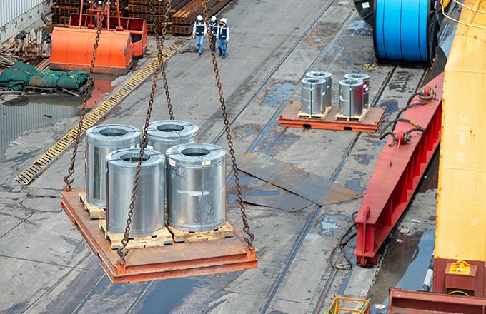 Loading of galvanized steel coils in cargo hold of cargo ship.
