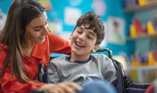 Autistic student happily learning from patient teacher