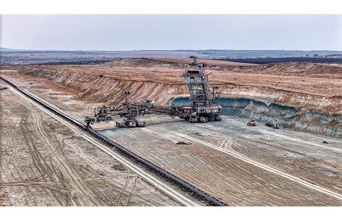 Open pit coal mine with huge backhoe digger