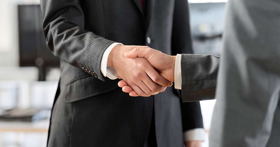 Asian business people shaking hands in the office