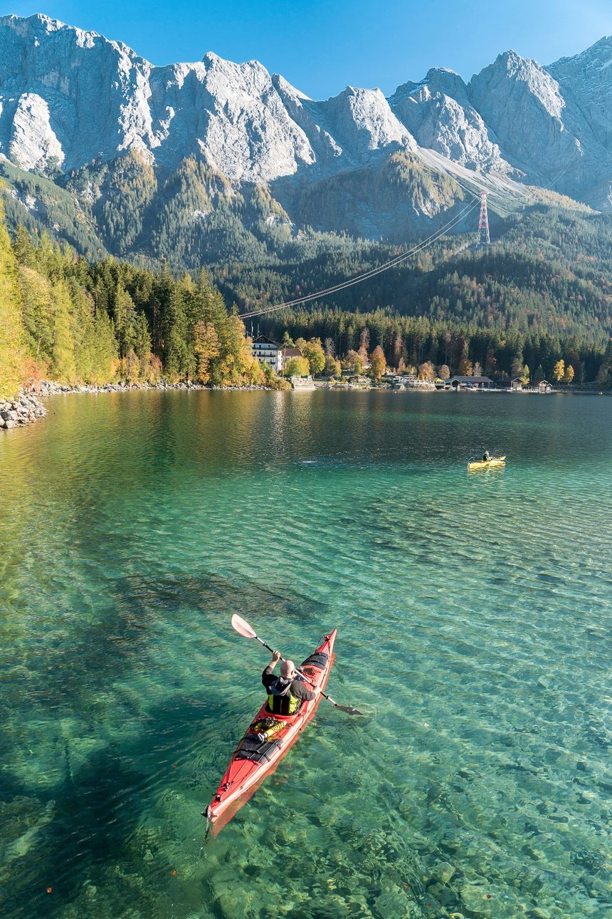 Kayaker on lake Eibsee with mountain Zugspitze