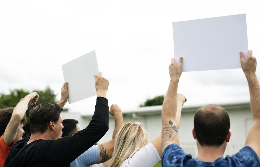 Rear view of activists showing papers while protesting